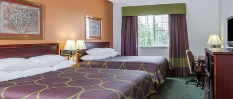 A hotel room with two beds, a desk, a chair, a television, and artwork on the walls.