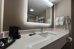 A bathroom with a sink, mirror, towel rack, and a hairdryer. - Super 8 by Wyndham Grayville (Grayville)