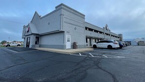 A building with a garage and a parking lot.