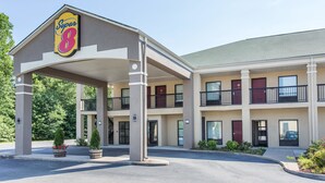 A Super 8 motel with a two-story structure, a covered entrance, and a parking lot. - Super 8 by Wyndham Petersburg (Petersburg)