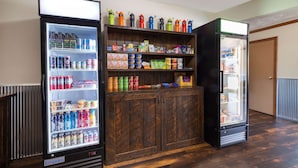 A room with three beverage dispensers and a wooden cabinet. - Travelodge by Wyndham Livingston Yellowstone (Livingston)