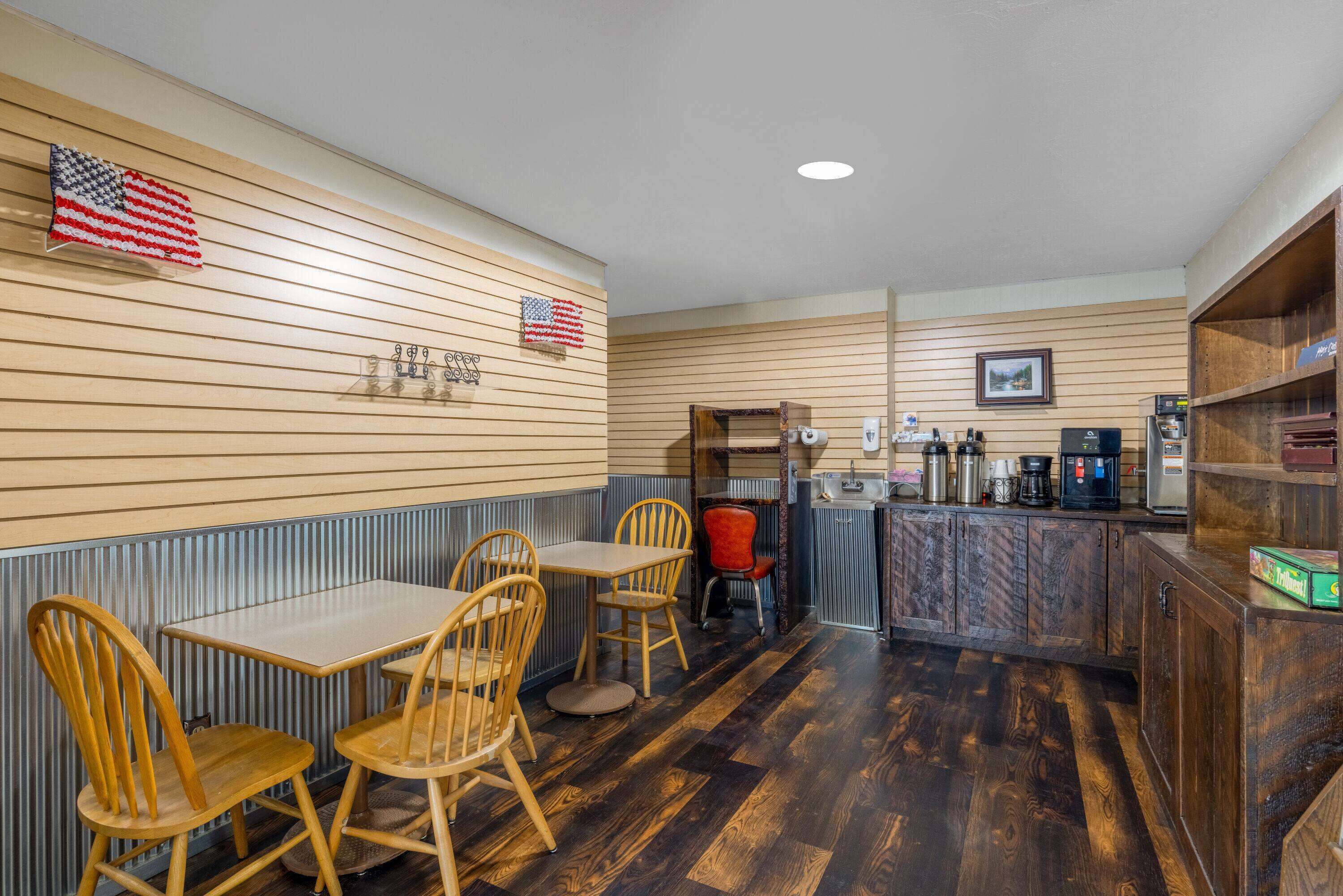 A restaurant with wooden panel walls, a bar area, and a seating arrangement with wooden chairs and tables.
