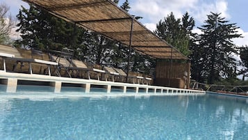 Seasonal outdoor pool, open 9:00 AM to 8 PM, pool umbrellas