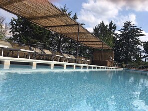 Seasonal outdoor pool, open 9:00 AM to 8 PM, pool umbrellas