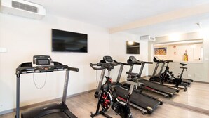 Ein Fitnessstudio mit Laufbändern, Ergometer und Rudergerät.