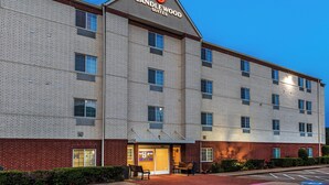 A multi-story hotel with a brick facade and a sign reading "Candlewood Suites." - Candlewood Suites Tyler by IHG (Tyler)