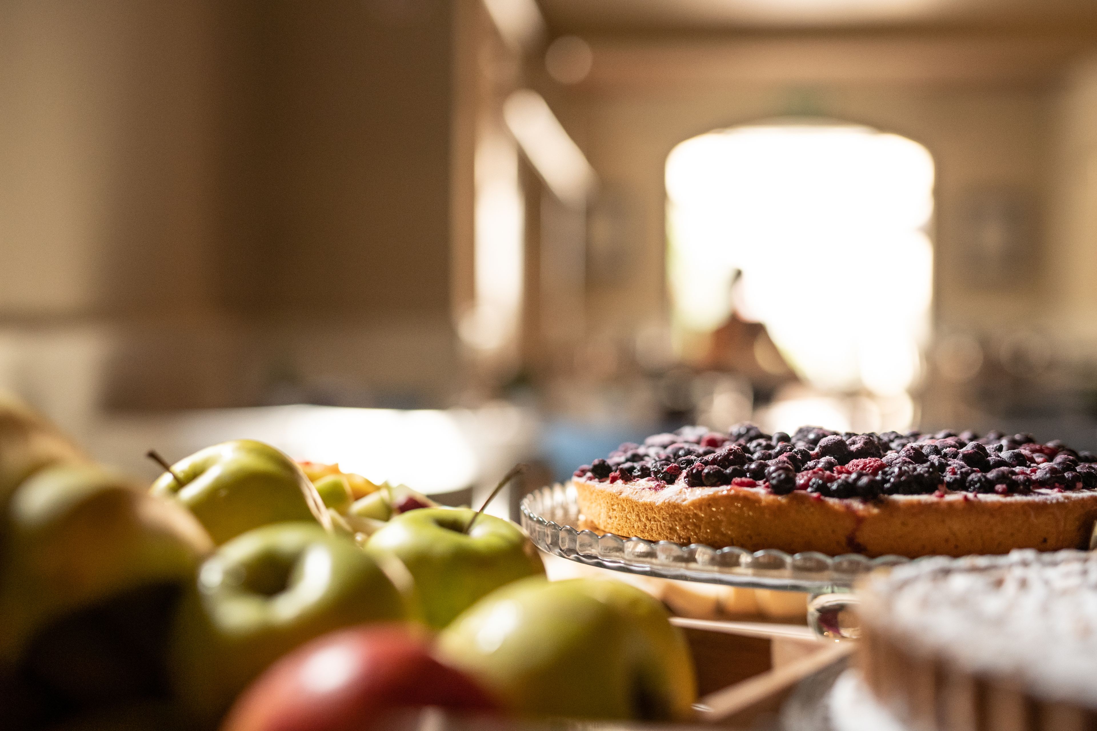 A table with a fruit platter and a pie.