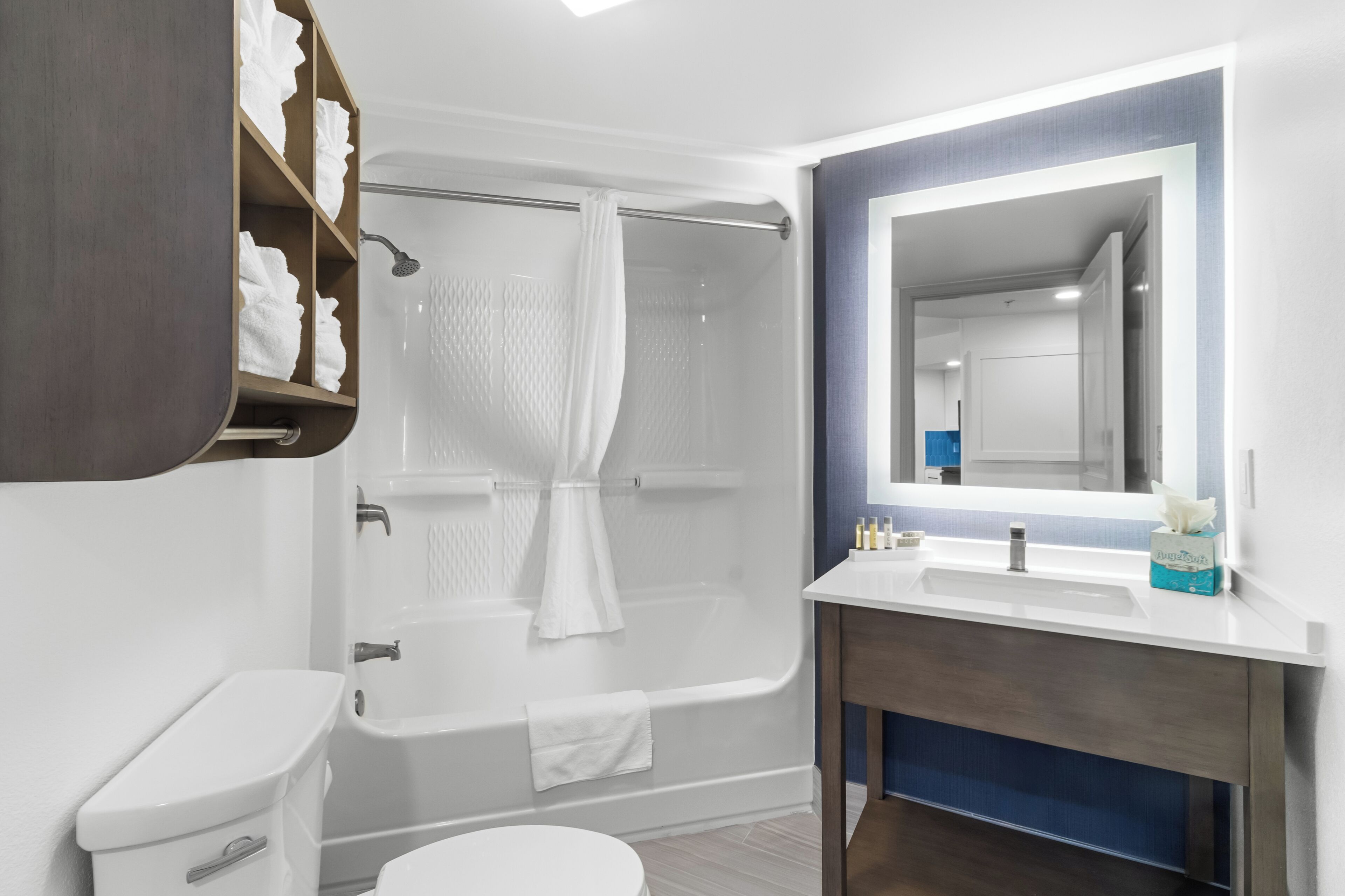 A modern bathroom with a bathtub, toilet, and sink.