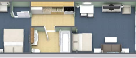 A hotel room layout with a bed, two seating areas, a kitchenette, and a bathroom.