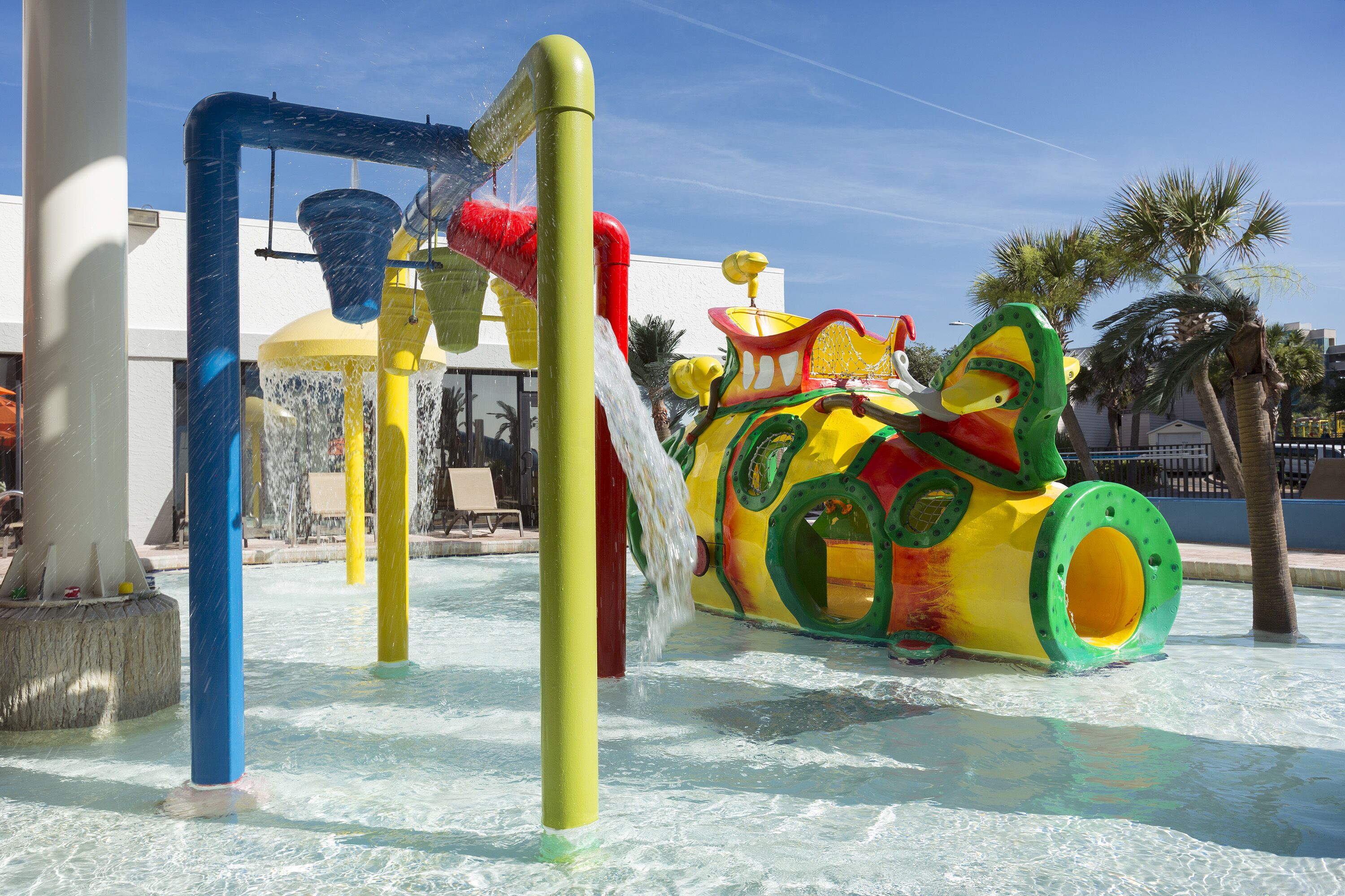 A water play area with a colorful slide and water jets.