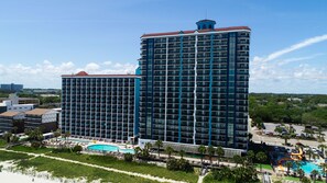 A high-rise hotel with multiple balconies, a swimming pool, and a water park. - Caribbean Resort & Villas (Myrtle Beach)