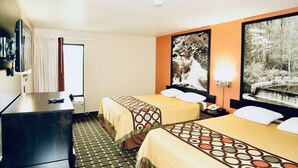 A hotel room with two beds, a desk, a TV, and artwork on the walls.
