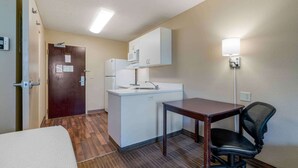 A compact room with a kitchenette, a bed, a desk, and a chair. - Extended Stay America Suites Sacramento Elk Grove (Elk Grove)