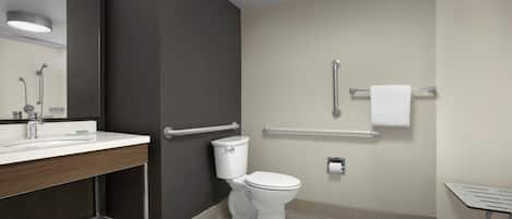 A modern bathroom with a toilet, sink, and shower.