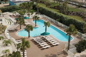 Una piscina cubierta, una piscina al aire libre, sombrillas, tumbonas