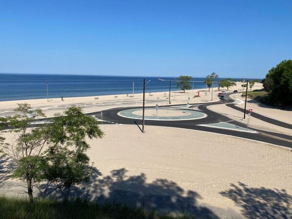 A roundabout with a beach view, clear skies, and sparse vegetation. - Fairfield Inn and Suites by Marriott Muskegon Norton Shores (Muskegon)
