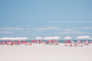 Relax on the expansive beach with comfortable sun loungers and shaded areas.