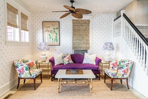 Relax in this stylish living room with a sofa, armchairs, and a coffee table.