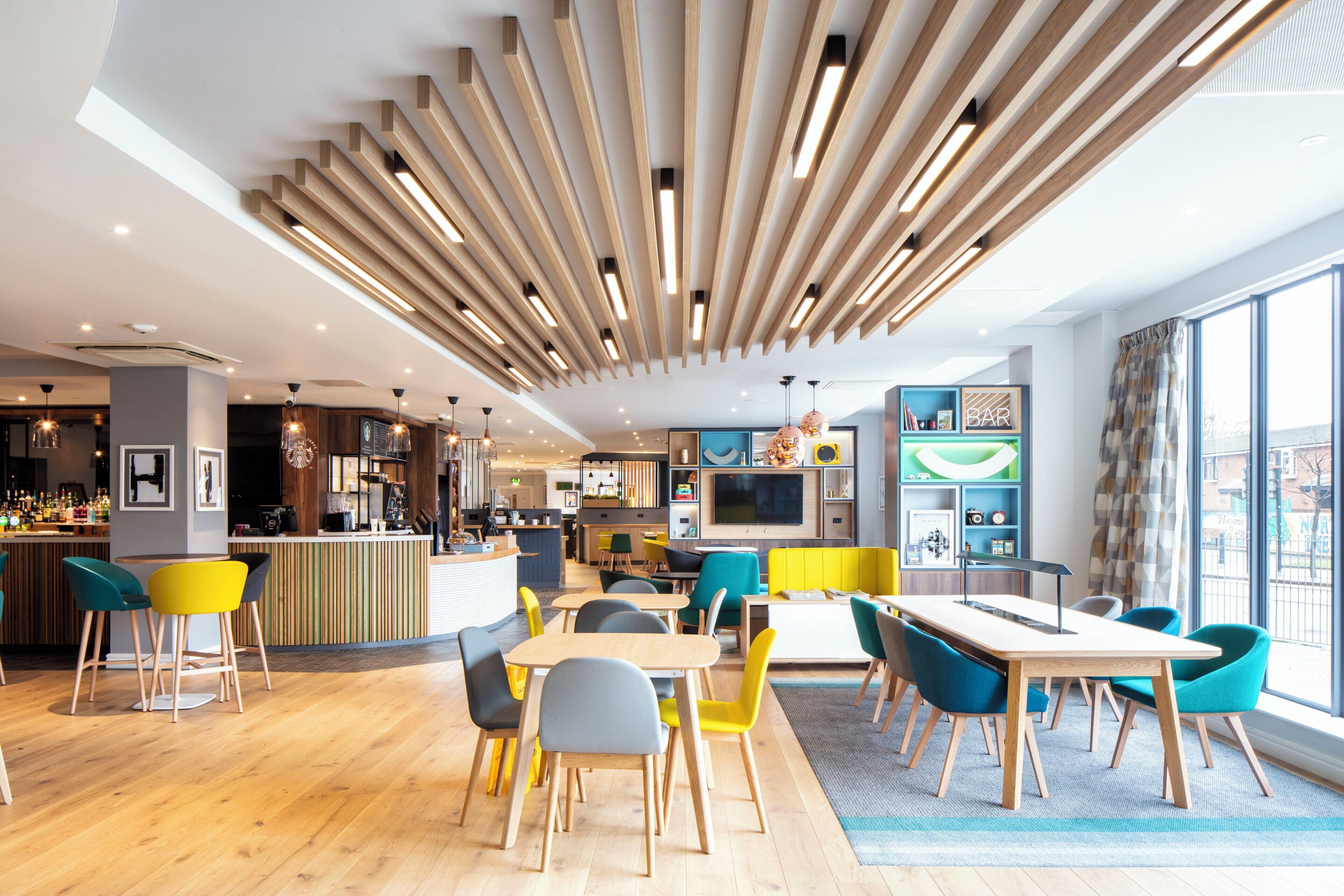A modern interior with a bar area, seating, and a large window.