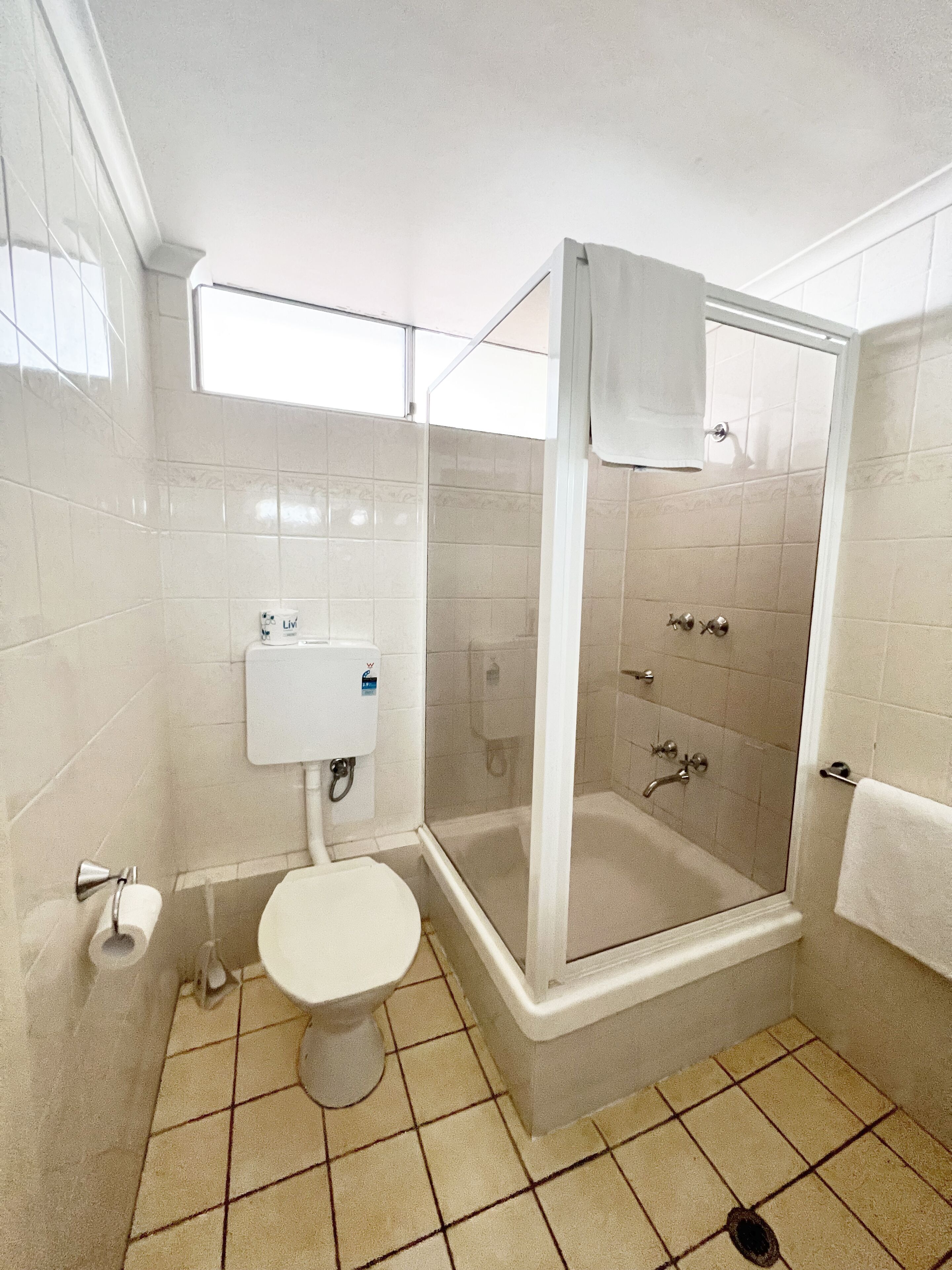 A bathroom with a toilet, a shower enclosure, and a bathtub.