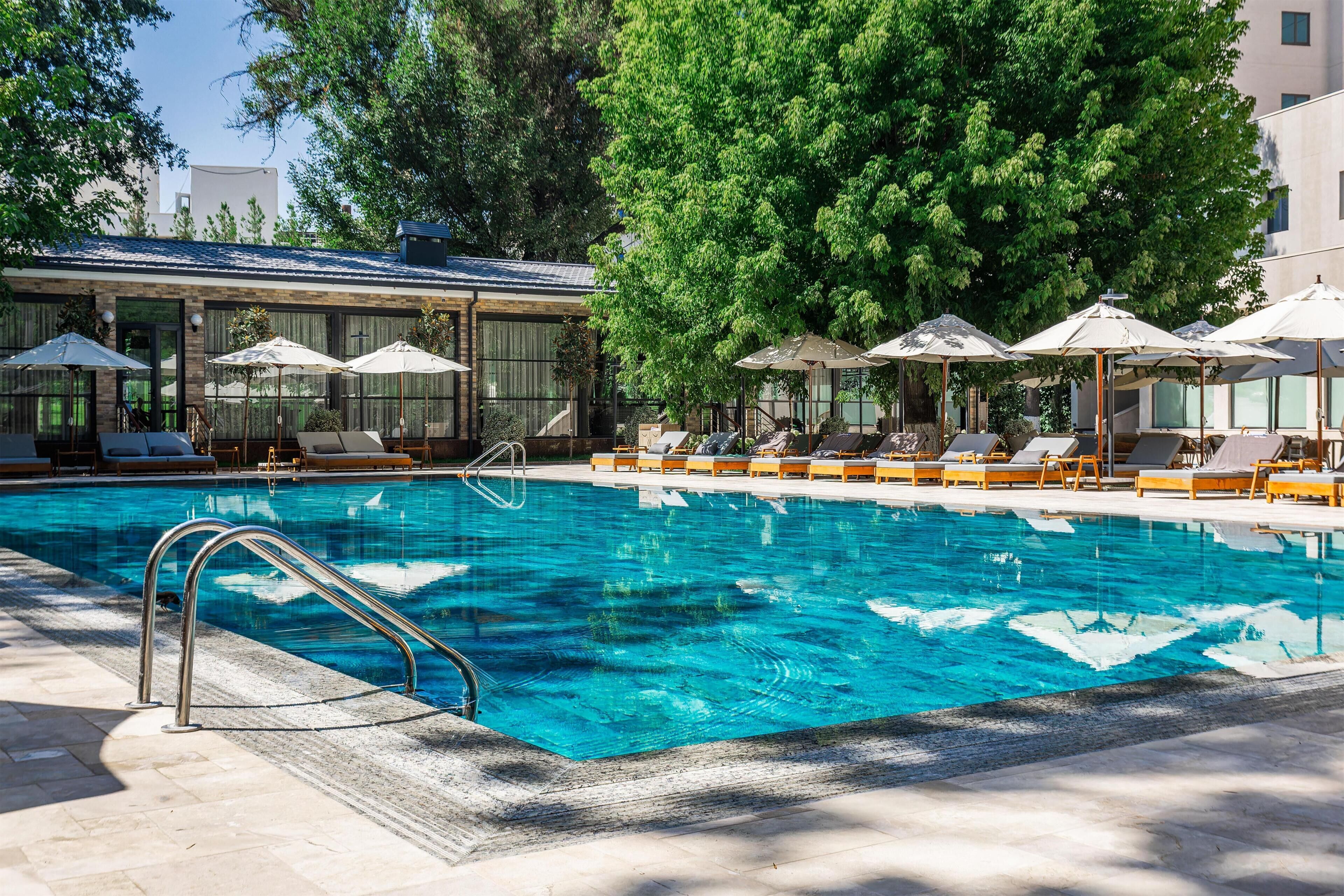 Seasonal outdoor pool, open 8:30 AM to 8:30 PM, pool umbrellas