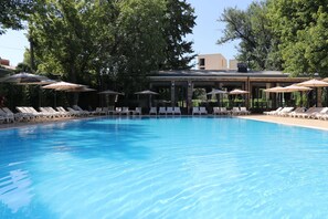Seasonal outdoor pool, open 8:30 AM to 8:30 PM, pool umbrellas