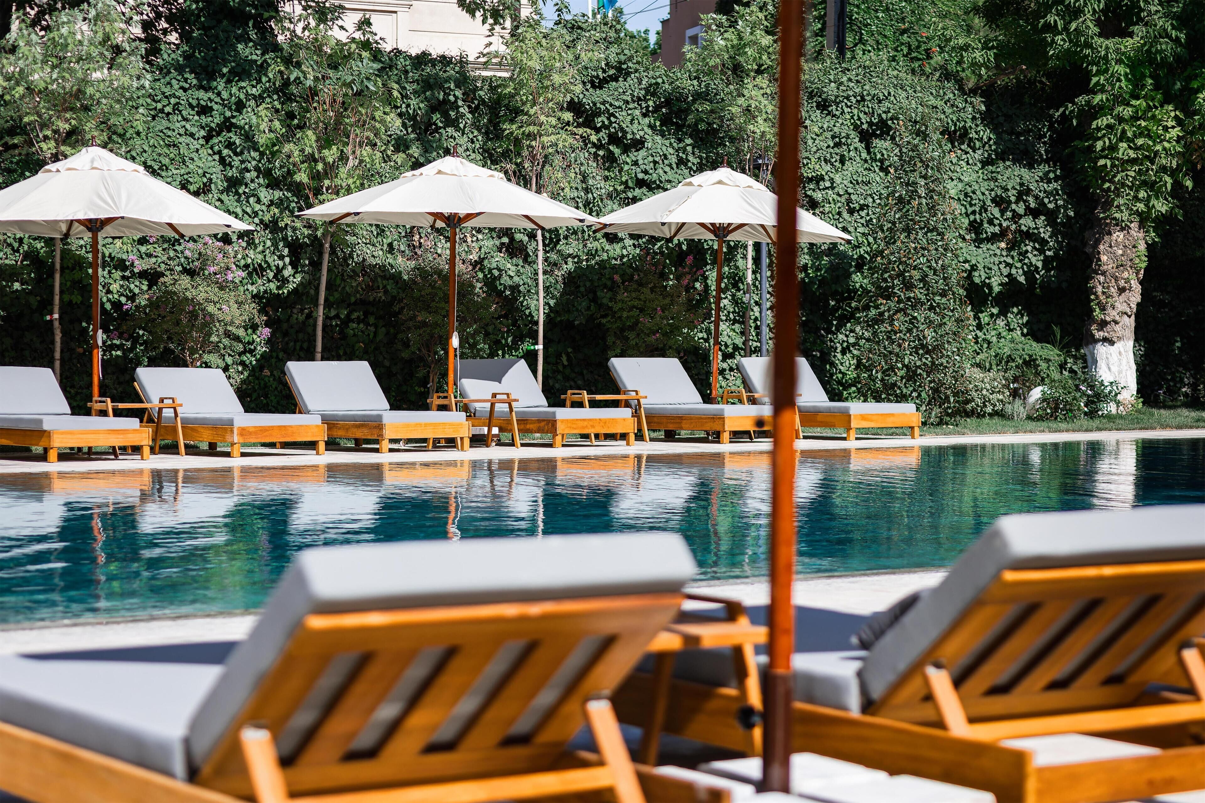 Seasonal outdoor pool, open 8:30 AM to 8:30 PM, pool umbrellas