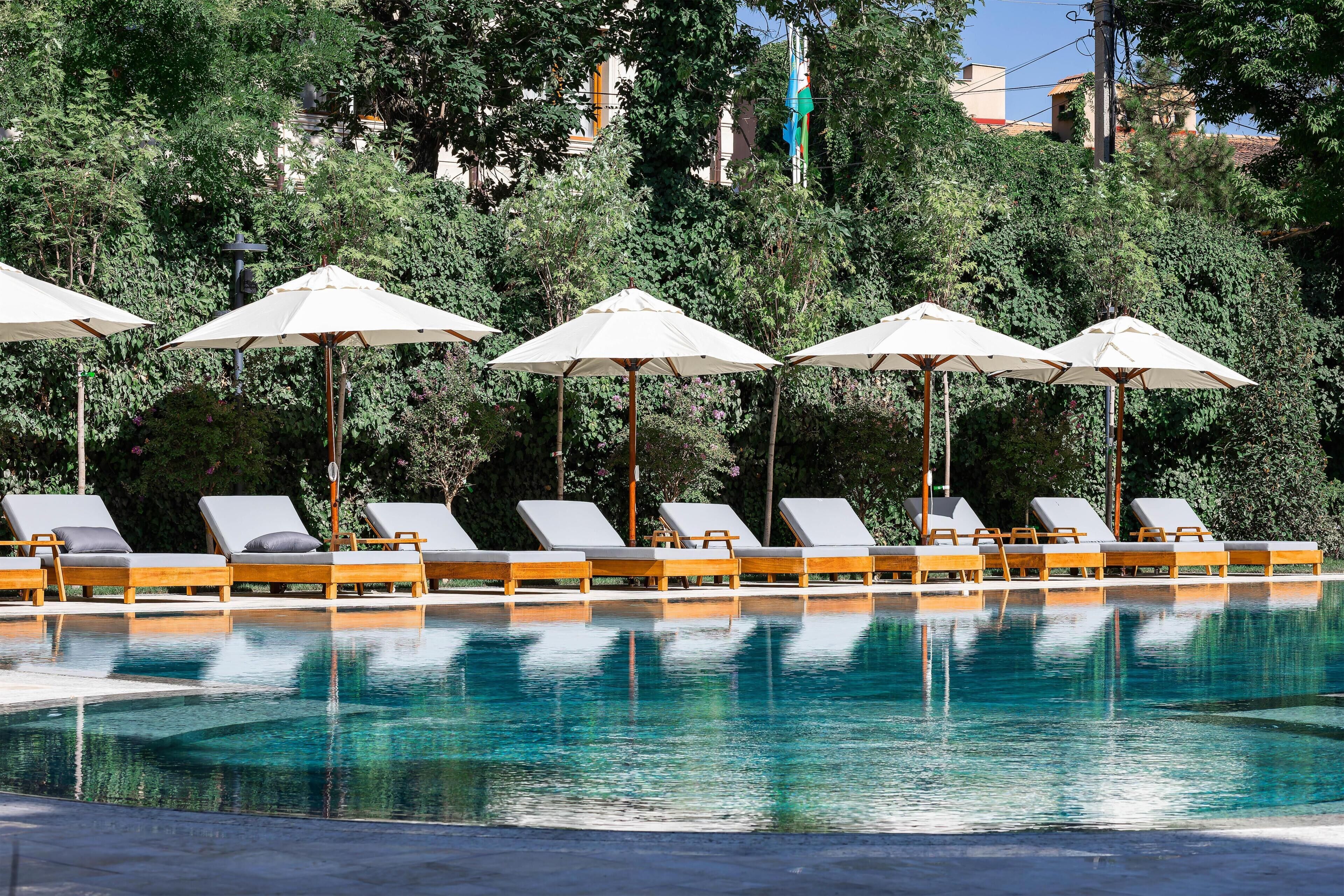 Seasonal outdoor pool, open 8:30 AM to 8:30 PM, pool umbrellas