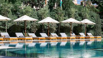 Seasonal outdoor pool, open 8:30 AM to 8:30 PM, pool umbrellas