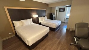 A hotel room with two beds, a desk, a chair, a TV, and a picture on the wall. - Econo Lodge (Sudbury)