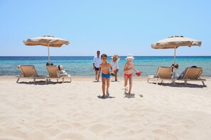 Private beach, white sand, sun loungers, beach umbrellas