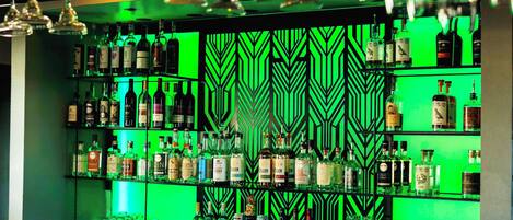 A bar area with shelves of liquor bottles and glasses.