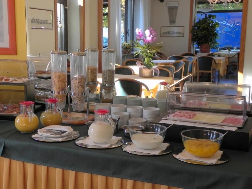 A buffet setup with various food items and beverages.
