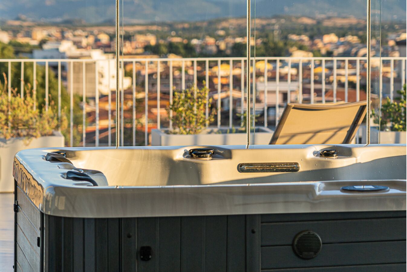 A hot tub on a balcony with a view of a cityscape.
