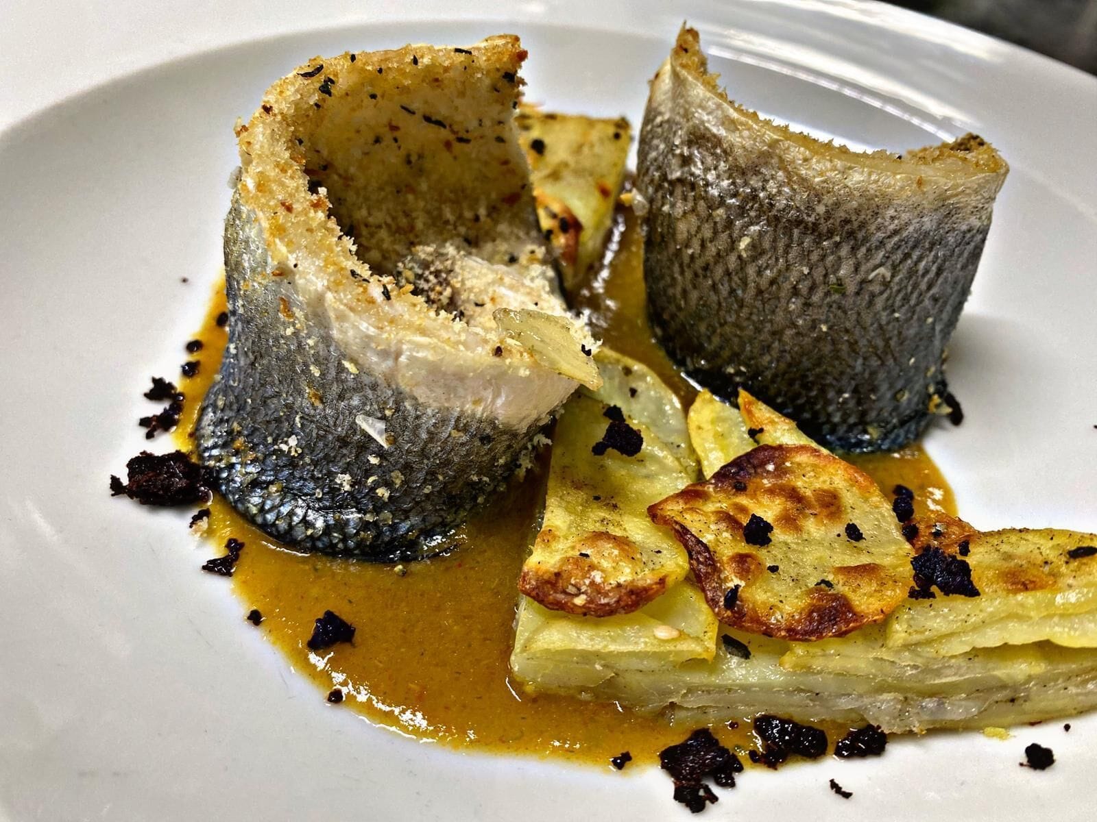 A dish with fish and potatoes.