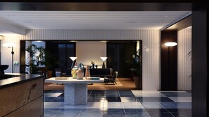 A modern lobby with a checkered floor, a central seating area, and a reception desk. - Grand Hotel Flora (Sorrento)