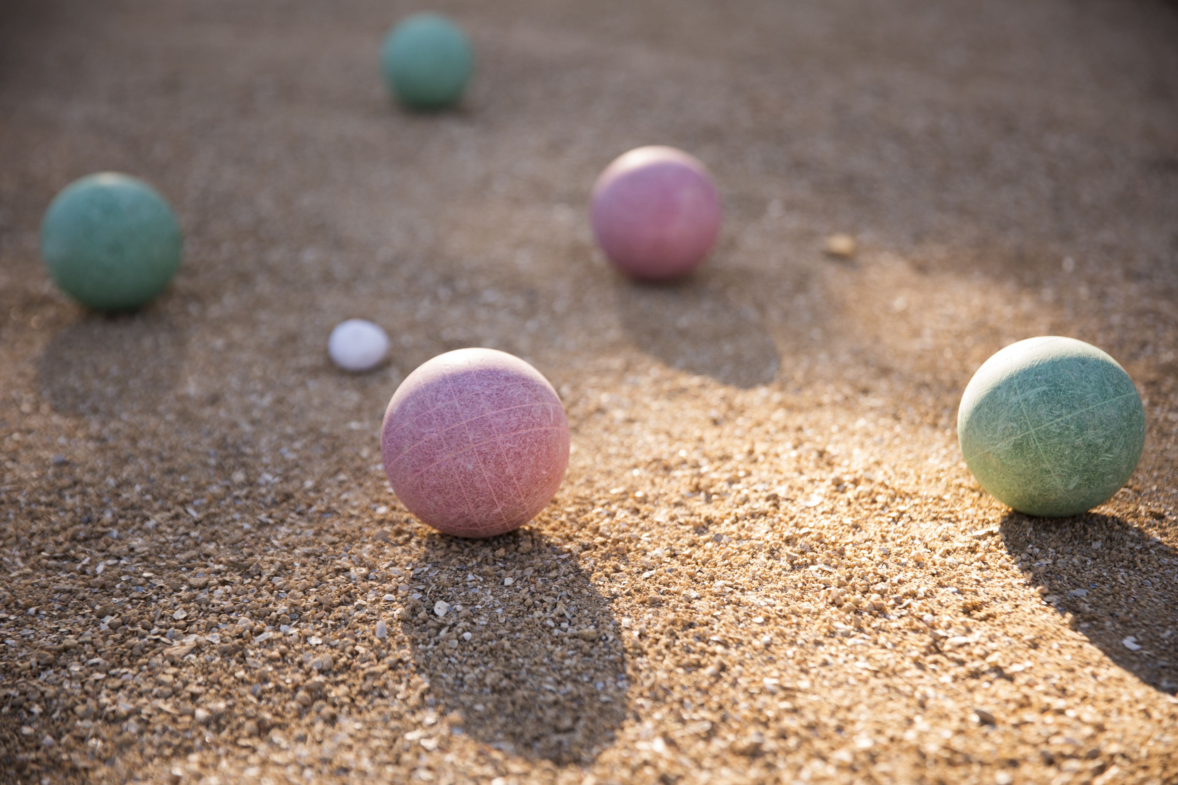 A sandy surface with several spherical objects.