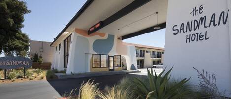The Sandman Hotel with a modern design, a clear signboard, and a well-maintained exterior.