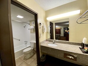 Separate bathtub and shower, hair dryer, towels