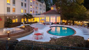 A hotel with a swimming pool, outdoor seating, and a garden area. - Hilton Garden Inn Montgomery East (Montgomery)