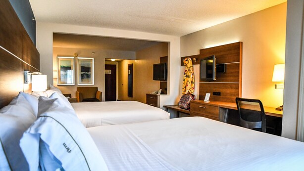 A hotel room with two beds, a desk with a chair, a television, and a mirror. - Holiday Inn Express Hotel & Suites Concord by IHG (Kannapolis)