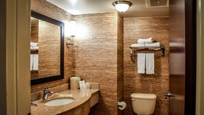 A bathroom with a marble sink, a toilet, and a towel rack. - Holiday Inn Express Hotel & Suites Concord by IHG (Kannapolis)