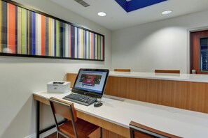 A modern office space with a long white table, a laptop, and an HP printer. - Holiday Inn Express Hotel & Suites Dayton-Centerville by IHG (Dayton)