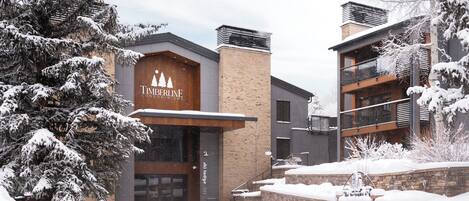 A modern building with a sign reading 'Timberline Condominiums.'