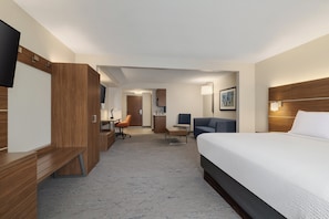 A hotel room with a bed, desk, chair, and a television. - Holiday Inn Express & Suites Indianapolis Dtn-Conv Ctr Area by IHG (Indianapolis)