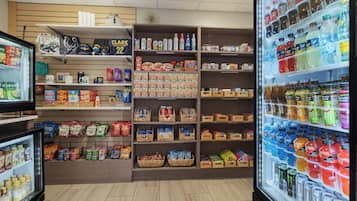 A grocery store with shelves stocked with snacks, beverages, and household items.