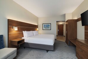 A modern hotel room with a large bed, bedside tables, a flat-screen TV, and a wooden wardrobe. - Holiday Inn Express & Suites Indianapolis Dtn-Conv Ctr Area by IHG (Indianapolis)