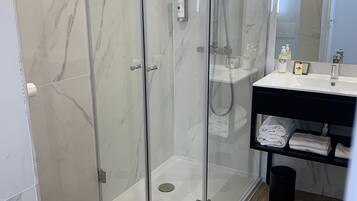 Shower, rainfall showerhead, hair dryer, towels