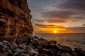 On the beach, white sand, sun loungers, beach umbrellas