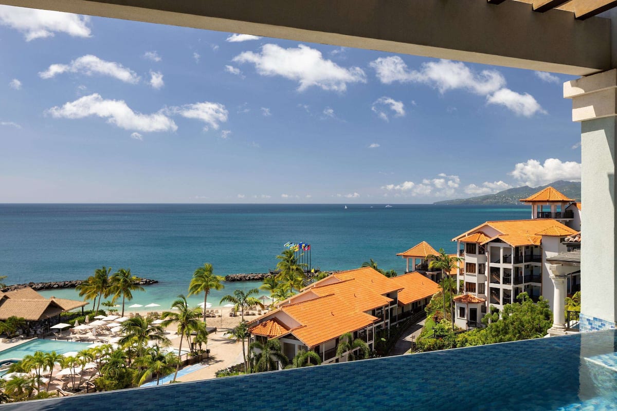 A resort with a pool, beach, and ocean view.